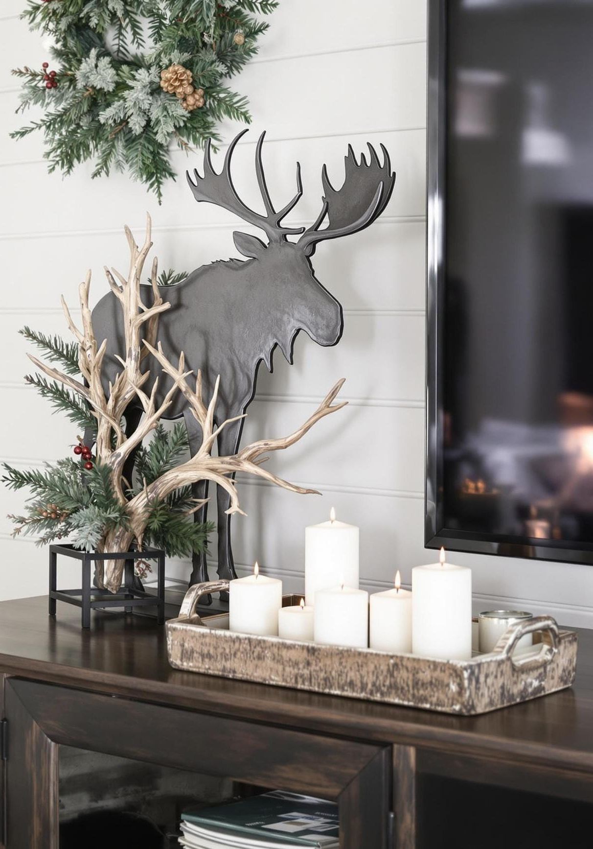 21 Trendy TV Stand Christmas Decor Ideas To Inspire You 25 11. Masculine TV stand with a moose silhouette, antlers, and a rustic wooden tray-1