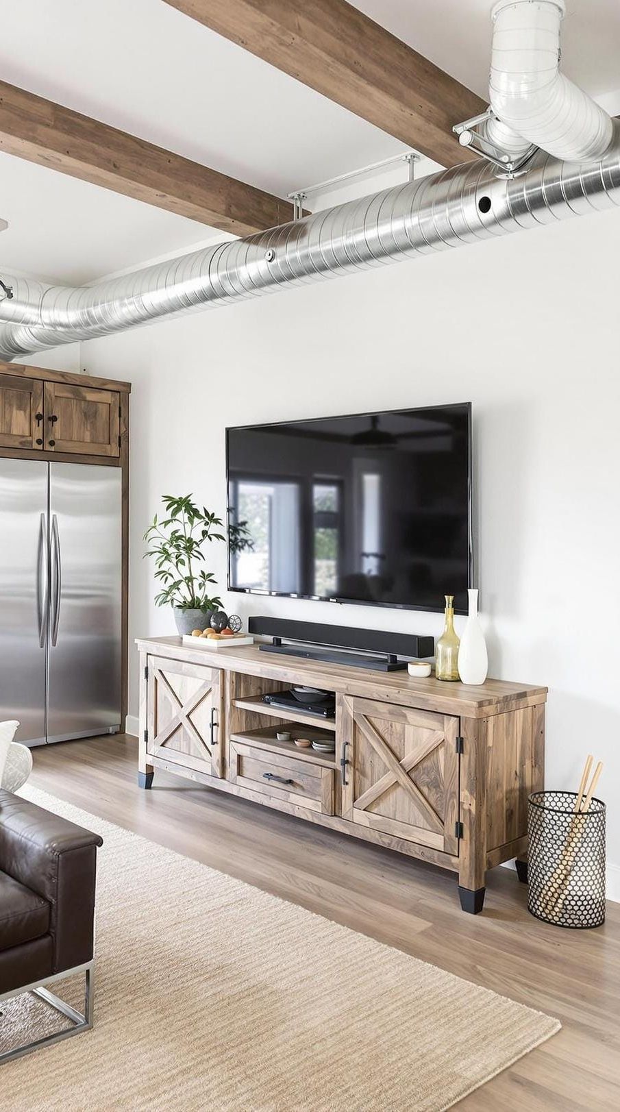 21 Best Industrial Farmhouse Living Room Ideas to Inspire 40 13. Display a rustic TV unit made from reclaimed timber and pair it with exposed ductwork and modern industrial cabinetry for a blended style-1