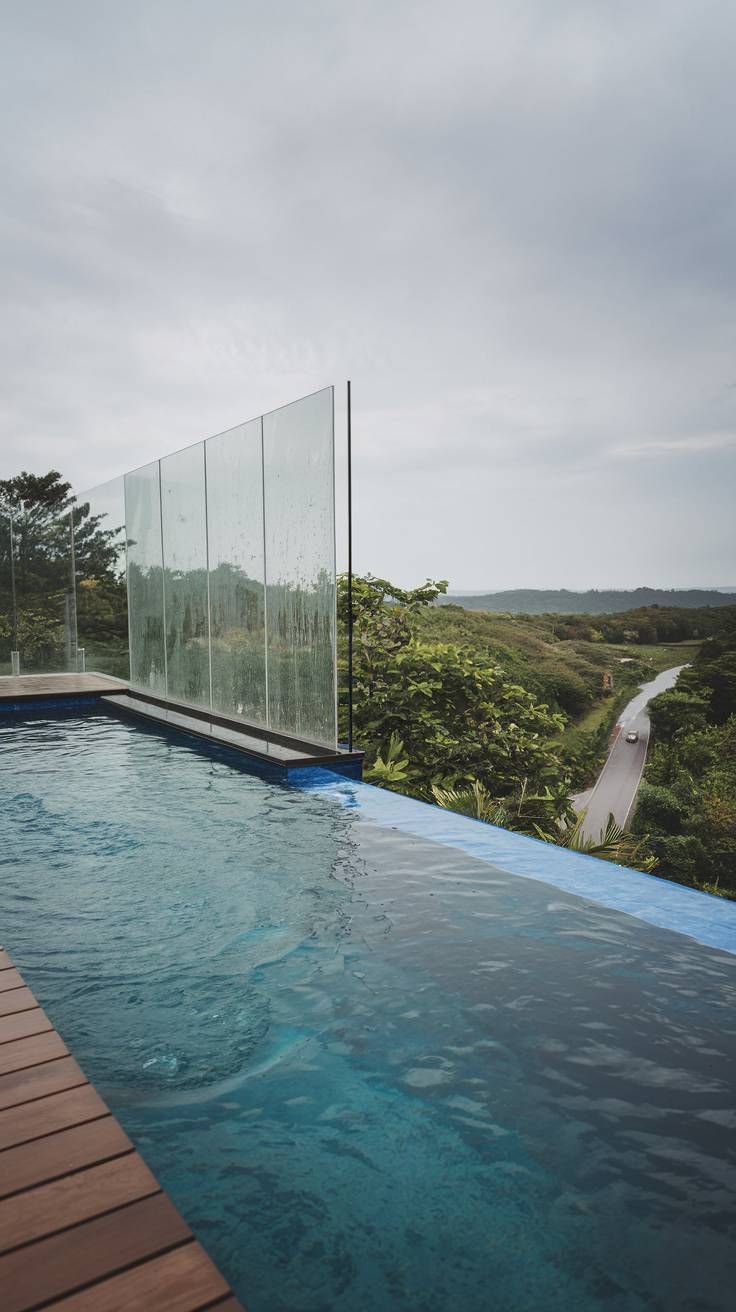 20 Pool Designs That Will Make a Splash in Your Outdoor Space 11 10. Luxurious Infinity Pool with Glass Railing