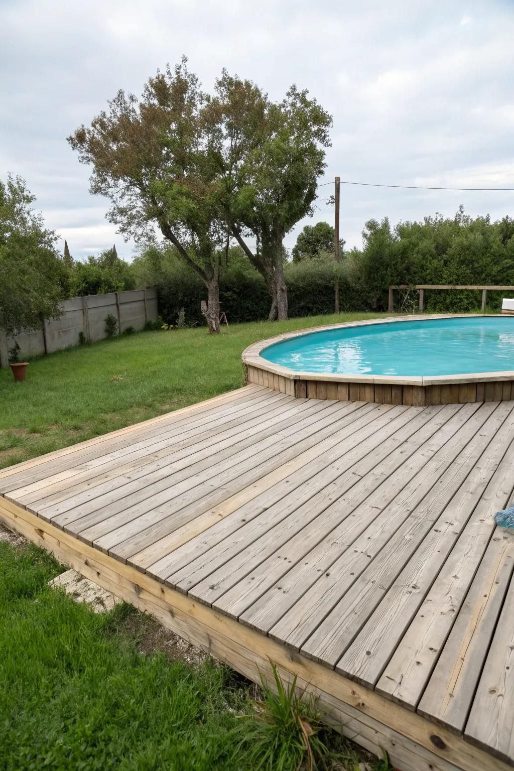 Wooden slats are a timeless, adaptable choice for any pool deck.