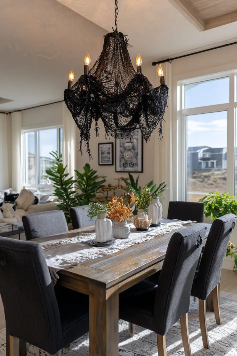21 Spooky Hacks for Unique Halloween Home Decorations Ideas 12 spooky chandelier made from black lace and dangling faux spiders 1